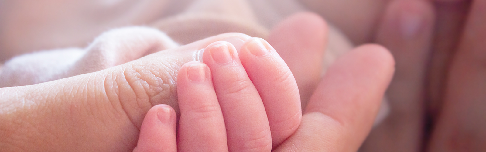 bigstock-Adorable-Little-Hand-Of-Newbor-432196532.png