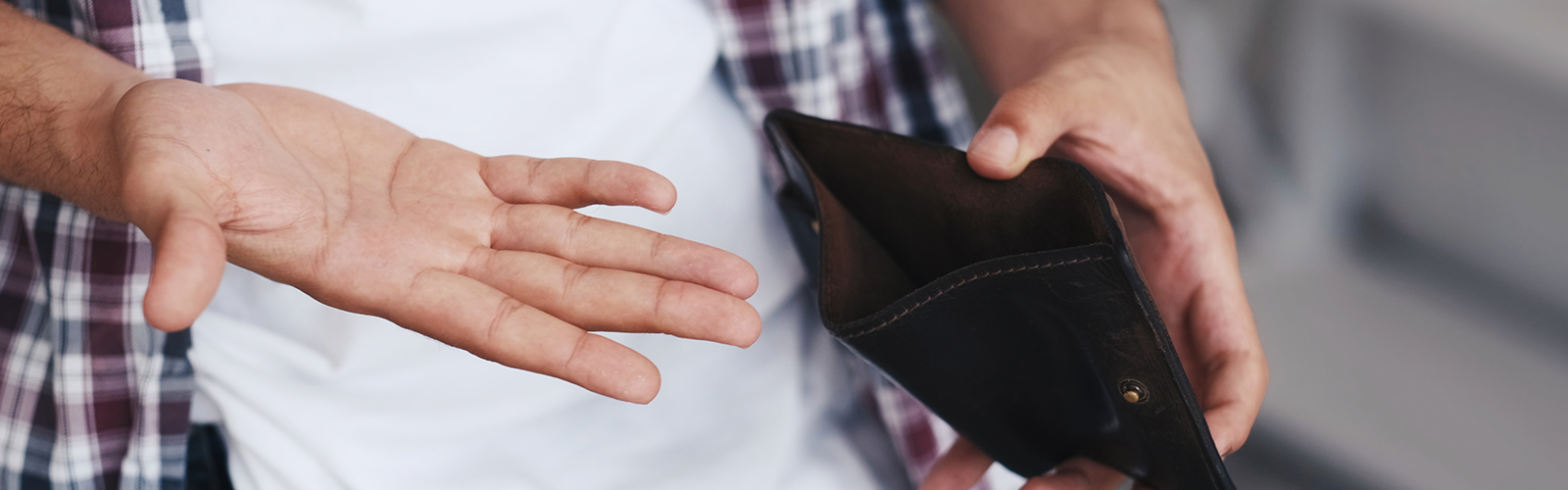 man holding open wallet - low pay - 472492151.png