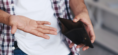 man holding open wallet - low pay - 472492151.png