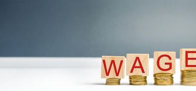 wooden blocks with increasing money and the word wage_284171950.jpg