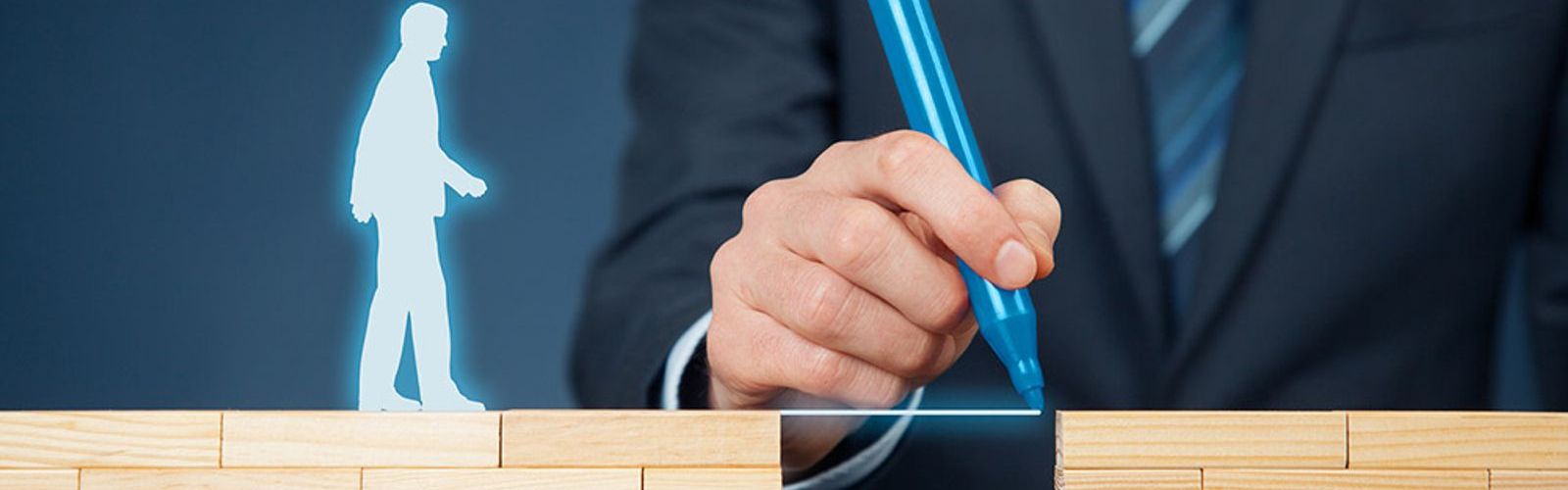 mans hand drawing a bridge between blocks - help-guidance (bigstock 127131332)_web.jpg