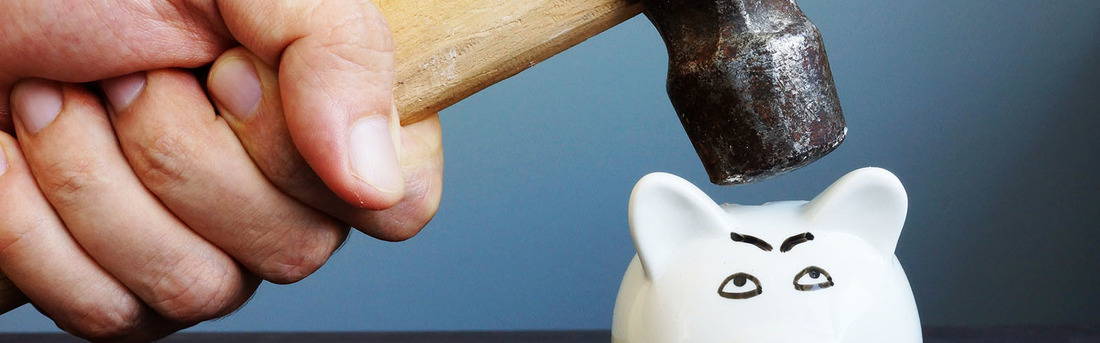 bigstock-Hand-With-Hammer-Above-A-Piggy-255361390_web.jpg