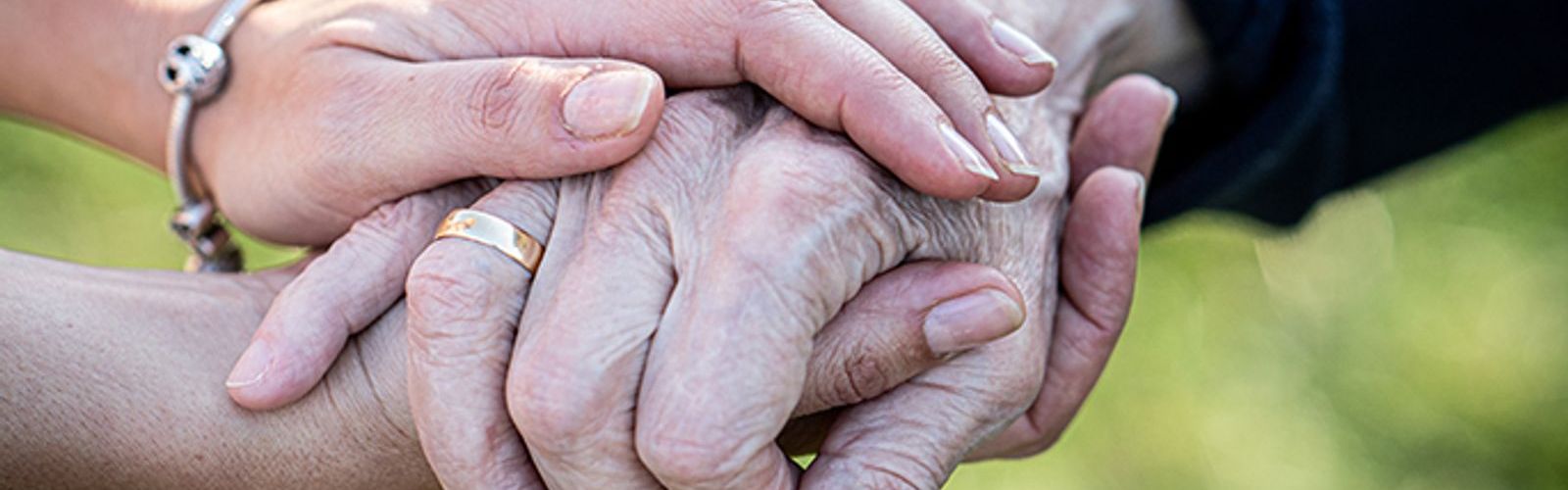 Caregiver-carer-hand-holding--358178528.jpg