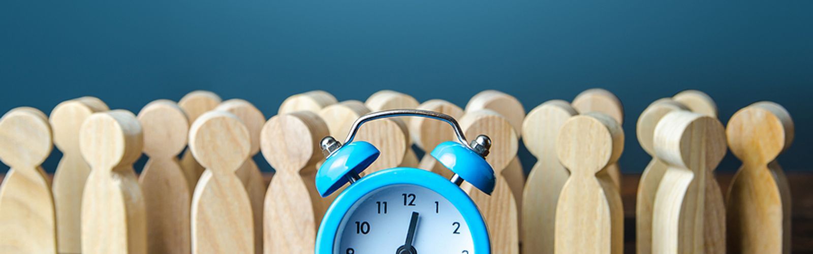 blue alarm clock with people pegs hours worked_bs442931051.jpg