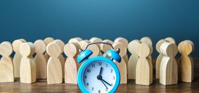 blue alarm clock with people pegs hours worked_bs442931051.jpg