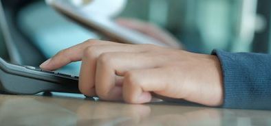 mans hand using calculator - payrolling benefits_web_1600x500.jpg