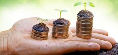 hand with stacks of money growing_220473742_web.jpg